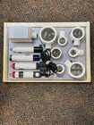 Eschenbach Illuminated Handheld Magnifier Set With 4 Handles 8 Heads Used. Price: $1000.00.