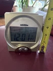 Reizen Talking Atomic Alarm Clock Date Calendar Gold Faux Wood Battery Operated Used. Price: $26.00.